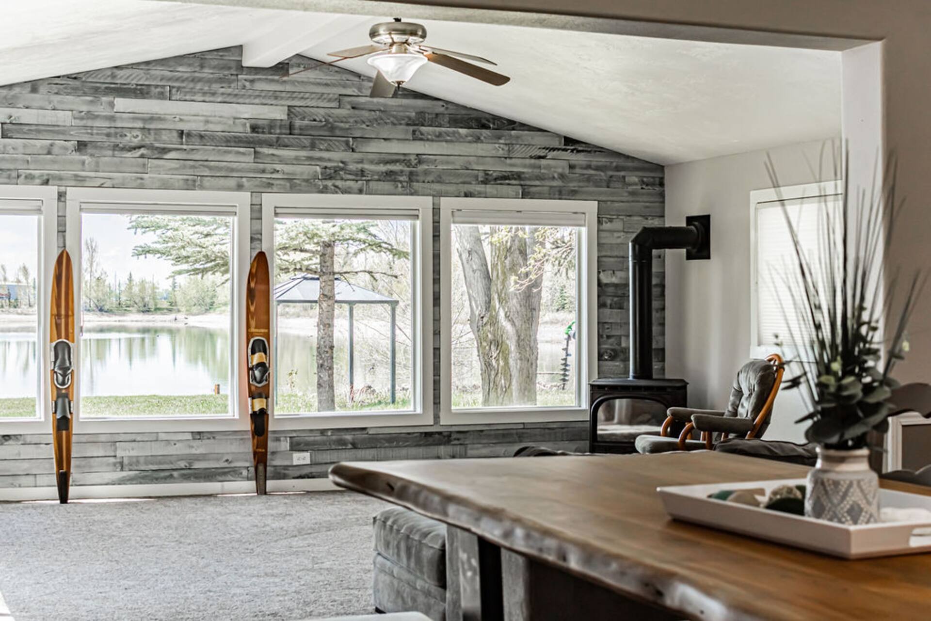 Living room with lake views and a wood stove